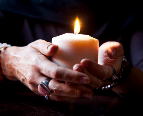 female hands holding a burning candle